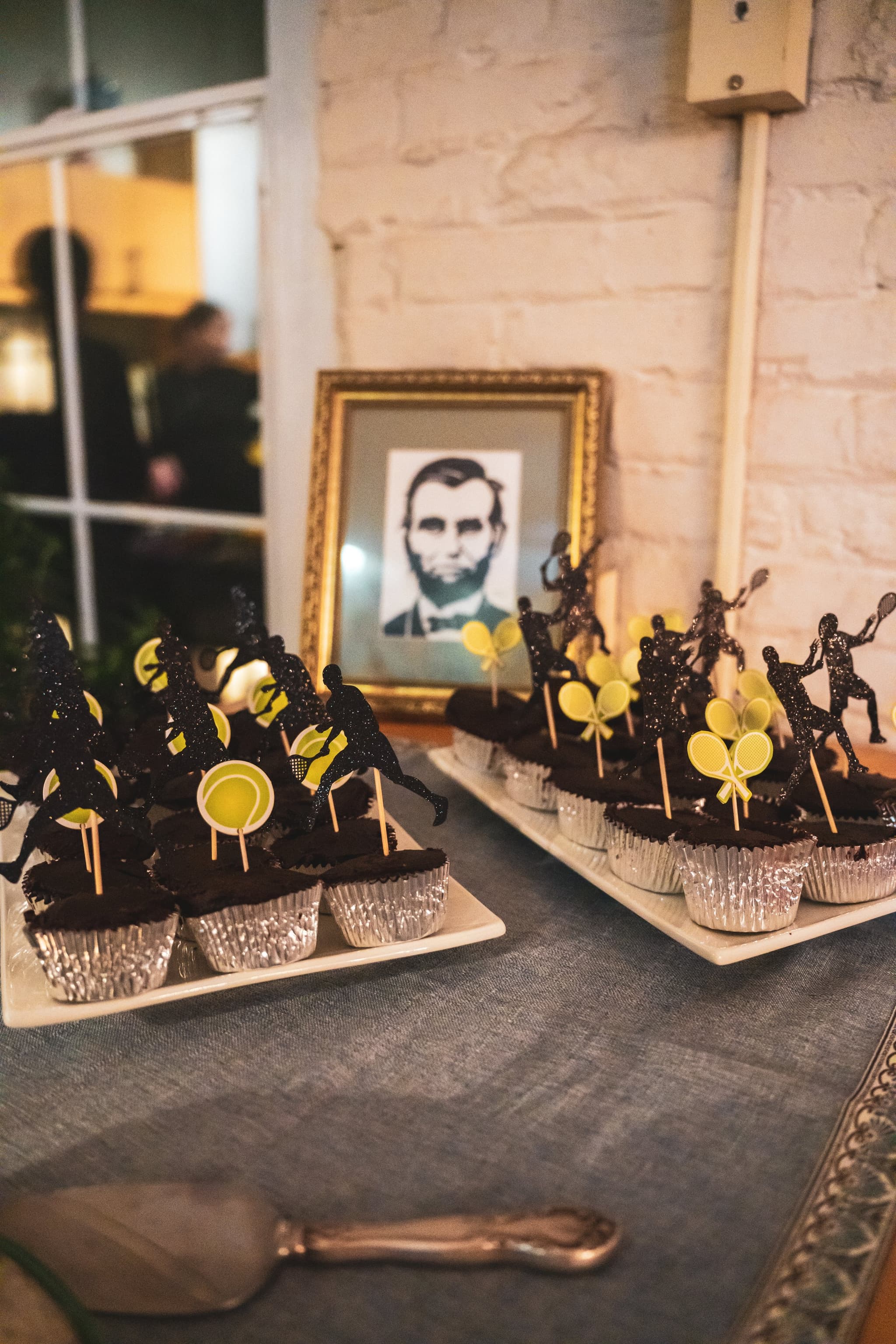 Styled dessert table with themed cupcakes and silhouette toppers
