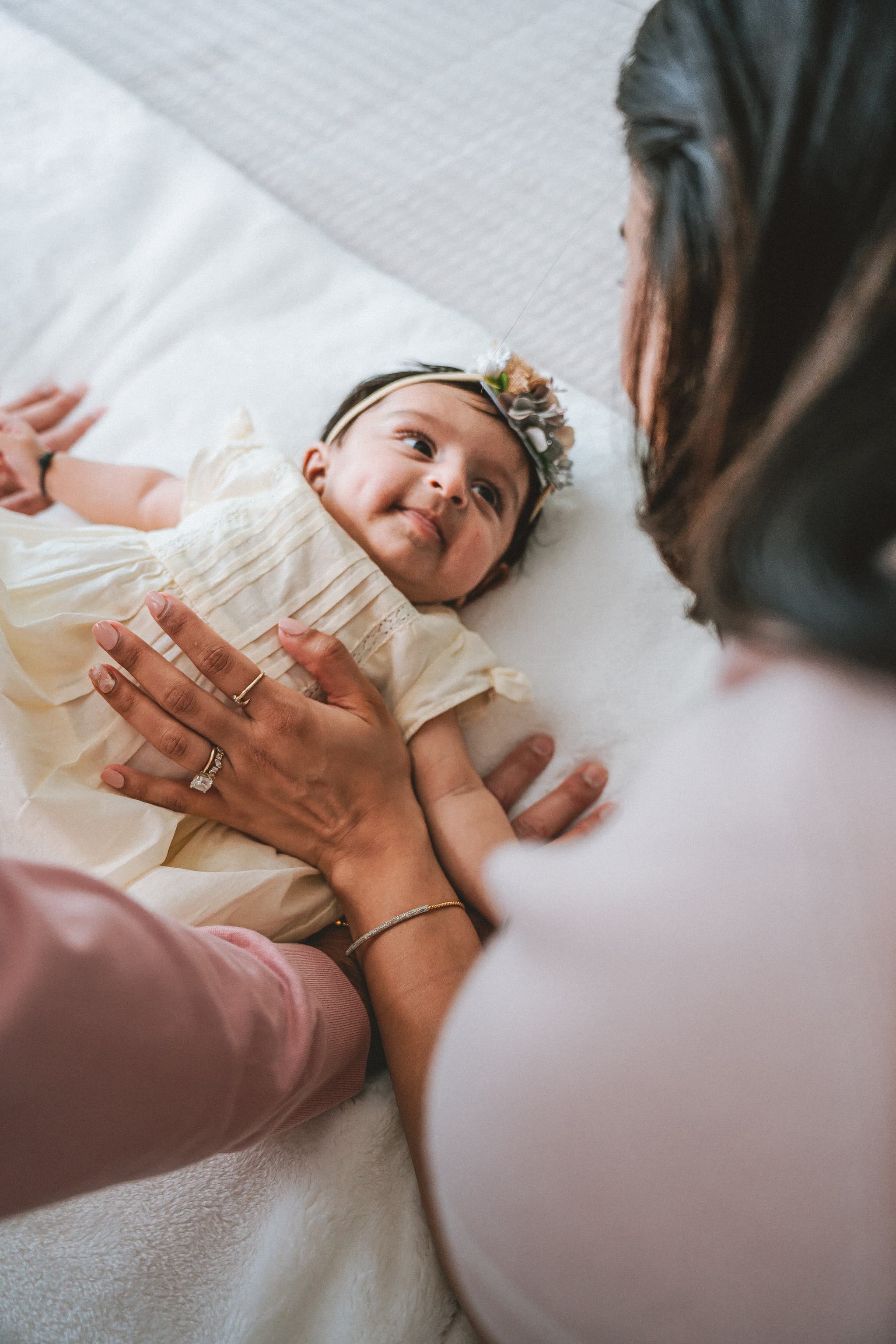 Serene close-up portrait of a sleeping newborn baby girl swaddled in a soft white blanket